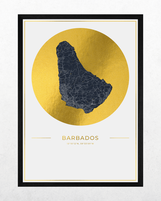 A framed minimalist art print of Barbados, featuring a dark charcoal map silhouette centered within a textured gold circular medallion on a white background, with the country name and coordinates printed below. The print is housed in a slim black frame.