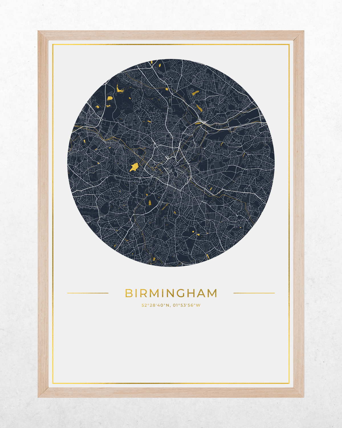 A framed circular map print of Birmingham, UK, featuring a dark navy blue map with white road lines and small gold highlights, set in a light wood frame against a textured off-white background.