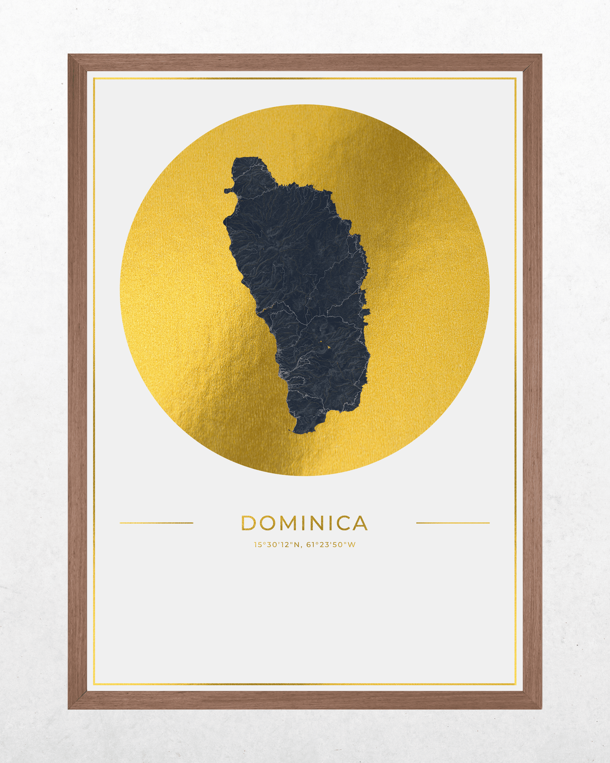 Framed wall art print featuring a dark charcoal map silhouette of Dominica centered inside a large metallic gold circle, with the word 'DOMINICA' and coordinates printed below on a white field, all enclosed in a brown wood frame.