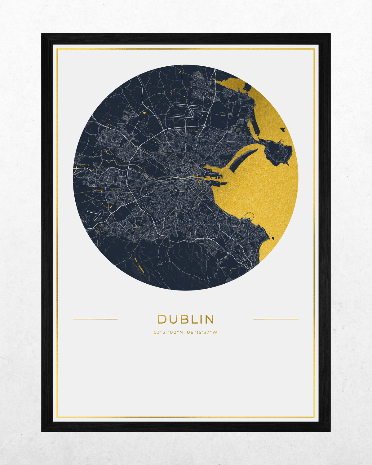 A framed city map print of Dublin, Ireland, featuring a circular navy and gold map design with the city name and coordinates printed below, set against a light textured background.