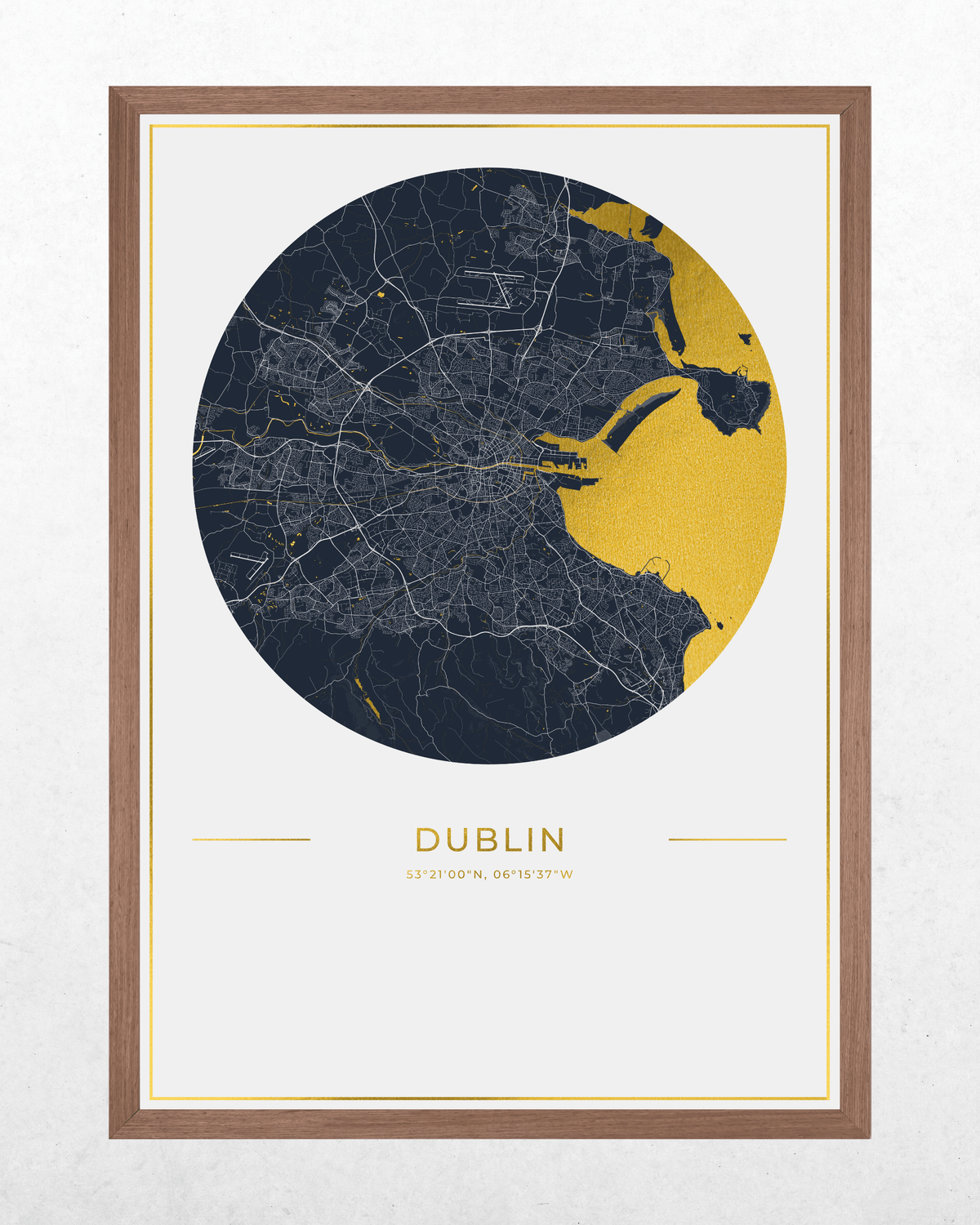 A framed circular city map print of Dublin, featuring a dark navy street map with a contrasting gold highlighted coastline and interior roads, set in a light wood frame on a textured off-white background.
