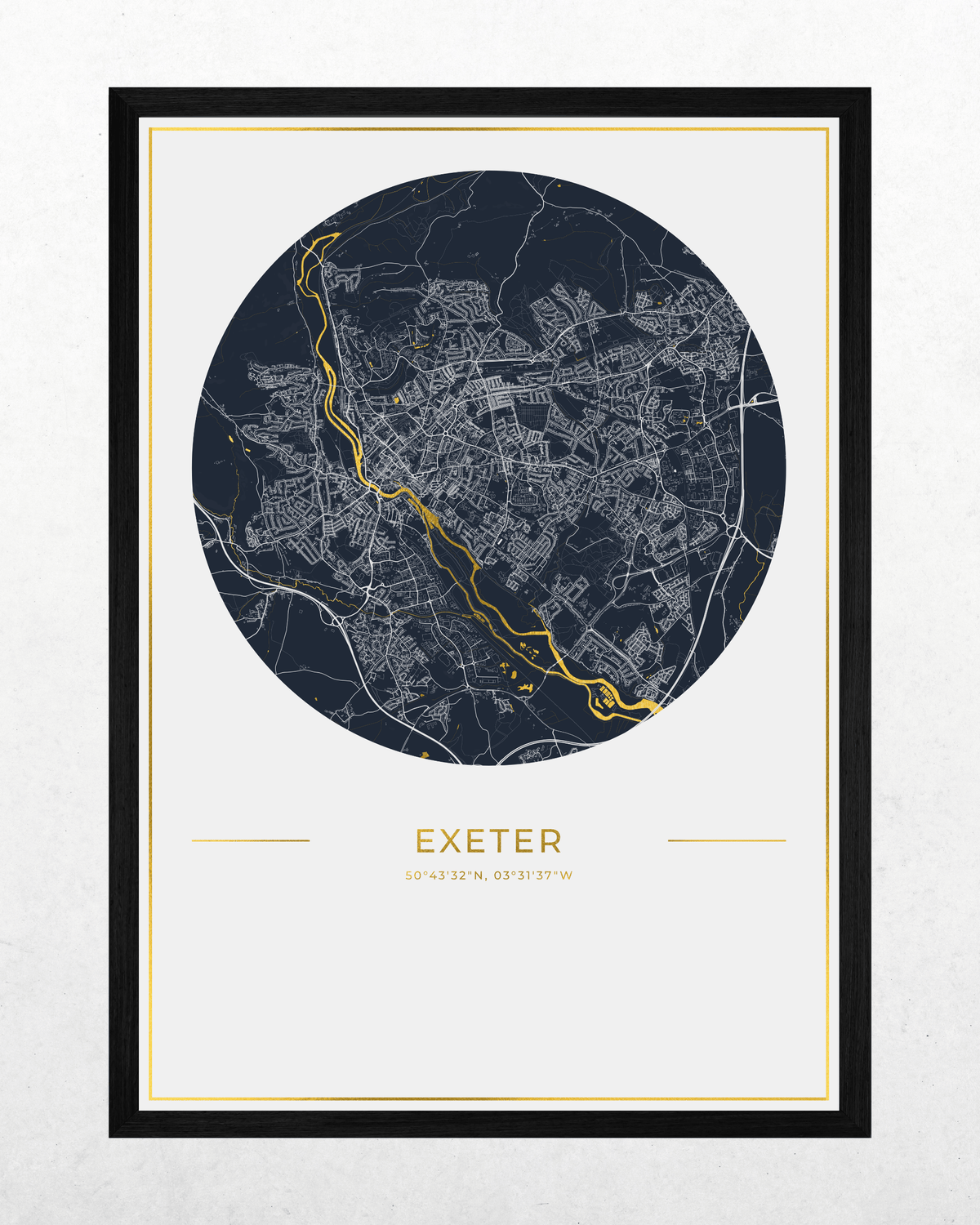 A framed circular city map print of Exeter, UK, featuring a dark navy blue map with white street lines and a highlighted gold river running through the center, presented in a black frame with a white mat on a light textured background.