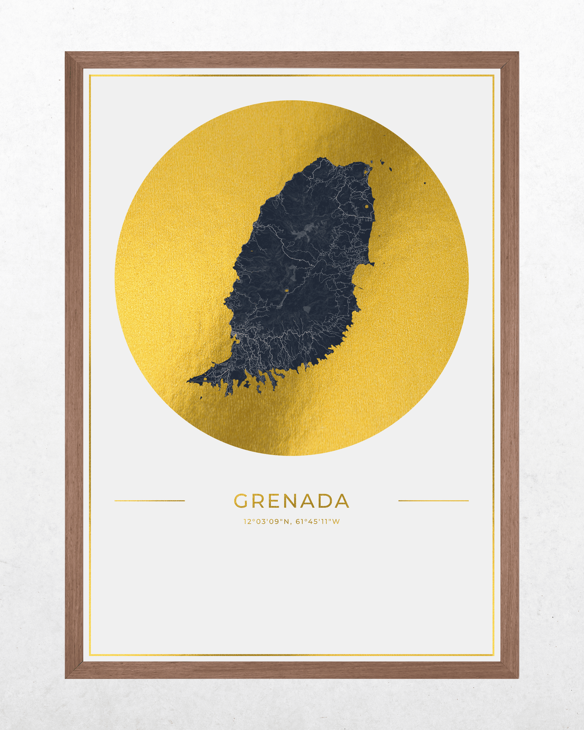 Framed wall art print featuring a dark navy map of Grenada centered inside a large metallic gold circle, with the word GRENADA and coordinates printed below on an off-white background. The print is housed in a medium brown wood frame and shown against a light textured wall.