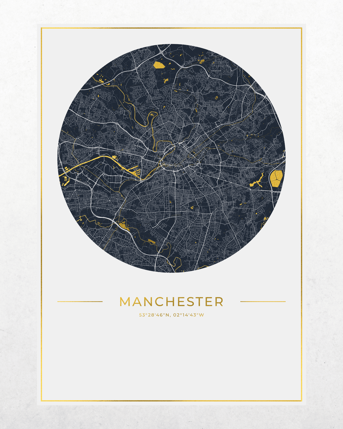 A minimalist circular city map print of Manchester, featuring a dark navy blue map with white street lines and gold highlights, framed by a thin gold border on a light textured background.
