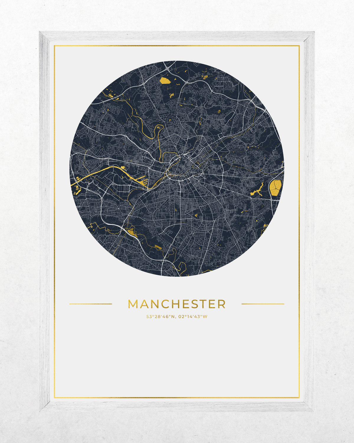 A framed circular city map print of Manchester, UK, featuring a dark navy blue map with gold highlights and the city name 'MANCHESTER' in gold below, set in a white frame against a light textured background.