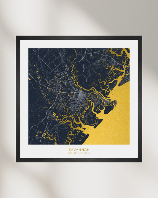 Framed Savannah city map art print with a black frame, white mat, and a navy, gold, and gray map design on a light gray background.