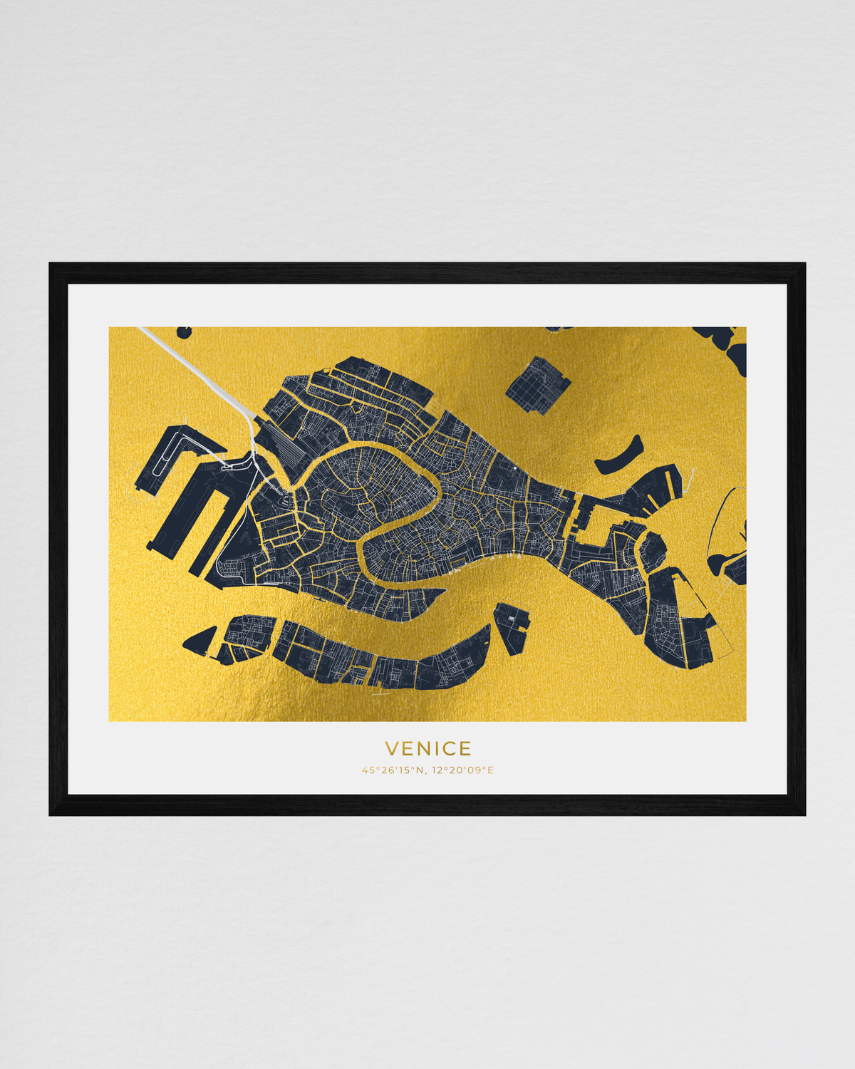 A framed map print of Venice, Italy, featuring a dark navy blue street grid over a textured gold background, enclosed in a black frame with a white mat.