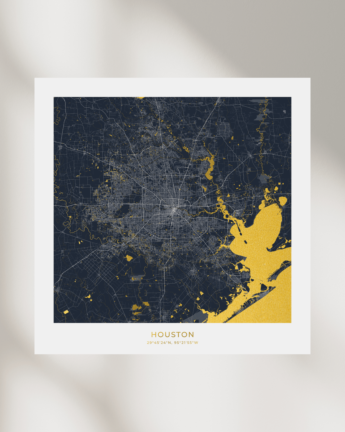 A framed-style city map print of Houston with a dark navy background, light gray street network, and gold highlights, shown against a soft beige background with subtle shadowing.