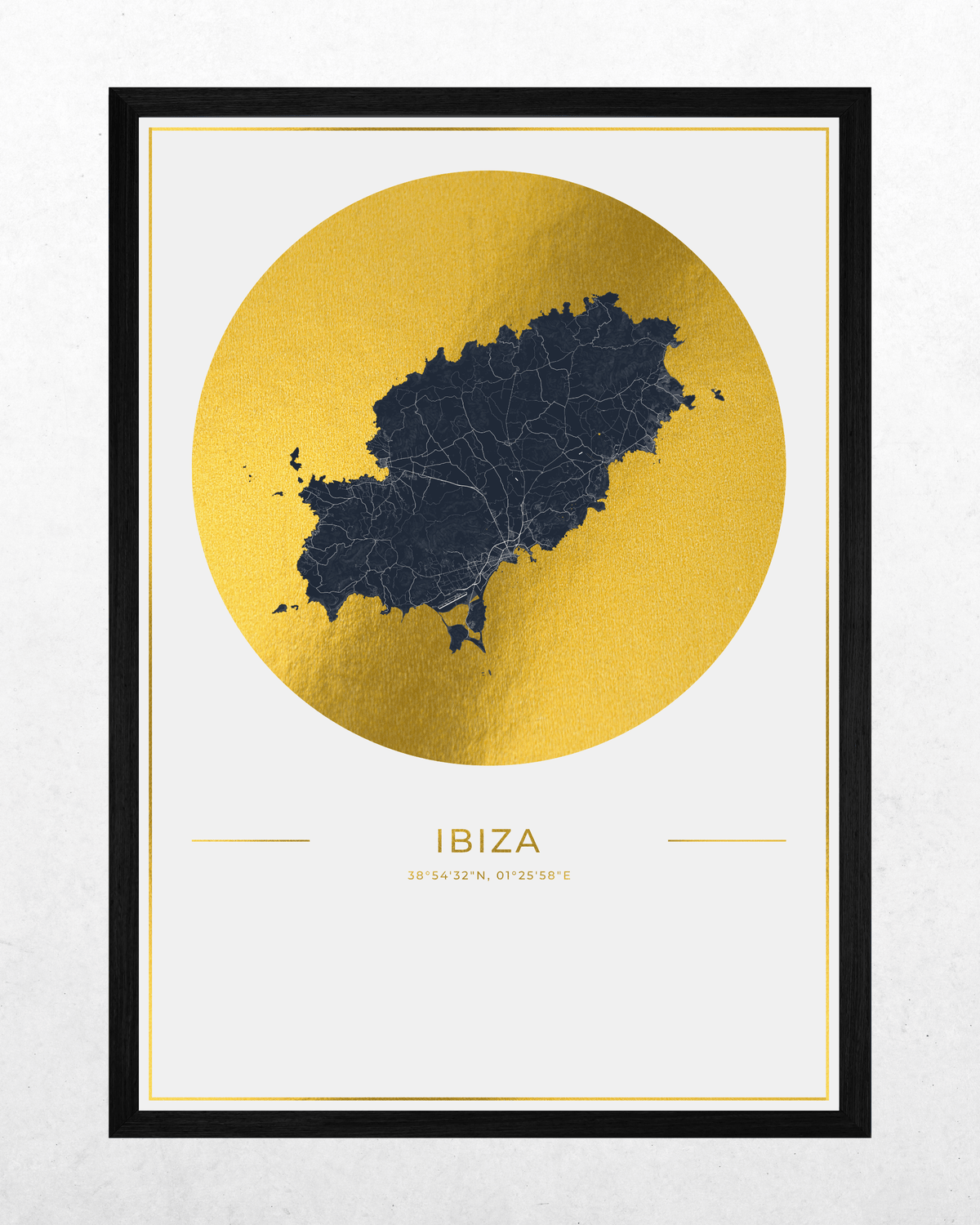 A framed minimalist art print of Ibiza, featuring a dark navy blue map silhouette inside a large textured gold circle on a white background, with the word 'IBIZA' and coordinates printed below. The print is housed in a slim black frame.
