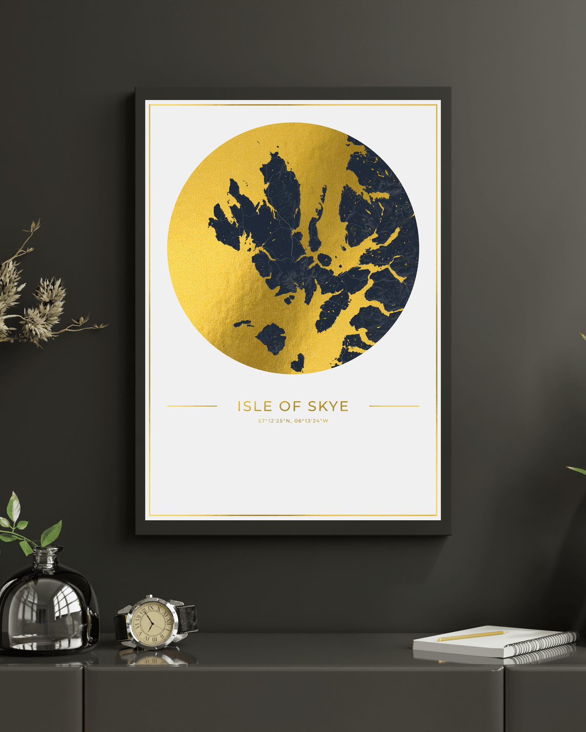 Framed wall art featuring a stylized gold and navy map of the Isle of Skye, displayed on a dark gray wall above a console table with decorative objects.