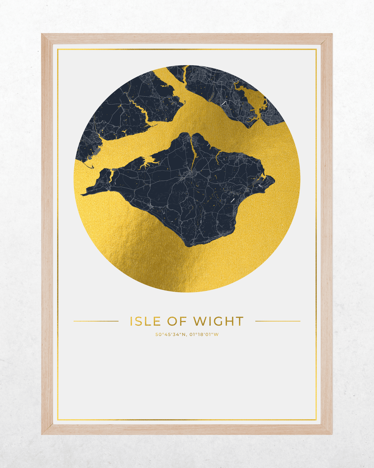 A framed art print featuring a gold foil map of the Isle of Wight, UK, in the shape of a circle with a dark navy blue landmass silhouette. The text 'ISLE OF WIGHT' and '20 43 24', '0 10 06' are printed below the circle.
