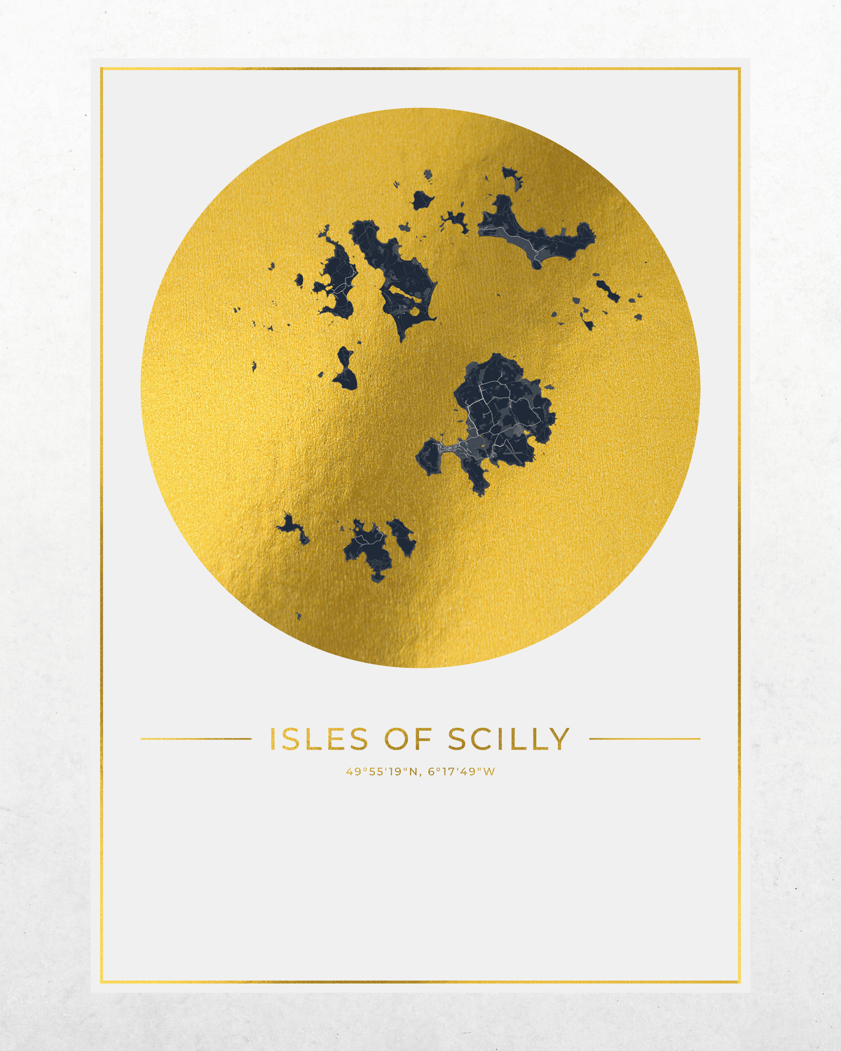 A minimalist art print featuring a textured gold circle with a dark blue map of the Isles of Scilly on a white background, framed by a thin gold border. Below the circle, the text 'ISLES OF SCILLY' is printed in gold along with coordinates.