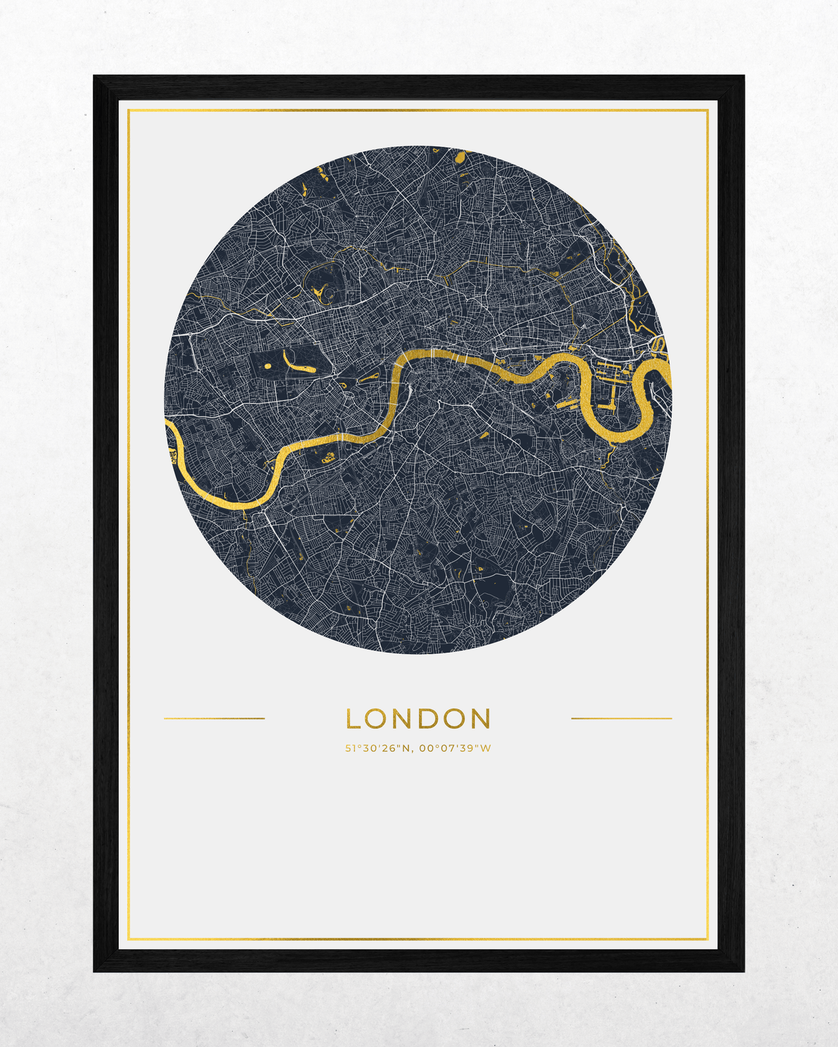 A framed London city map art print featuring a circular dark gray map with the River Thames highlighted in gold, set against a light gray background with the word 'LONDON' and coordinates printed below. The print is presented in a black frame with a white mat.