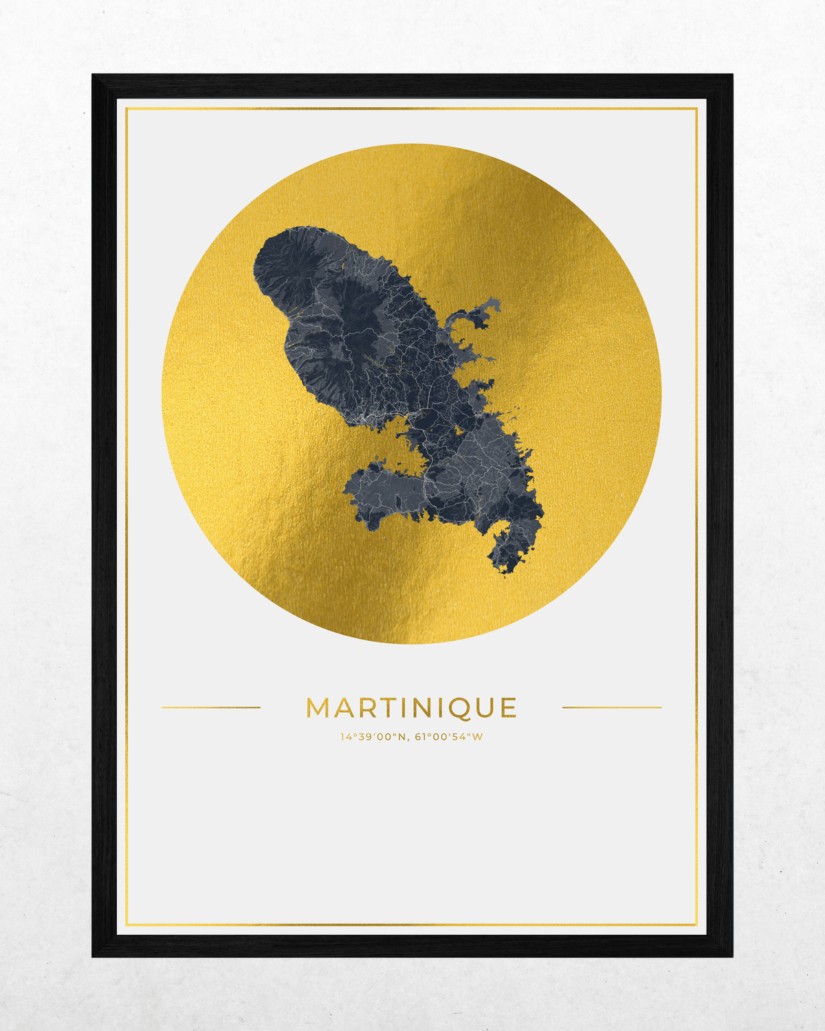 A framed travel poster of Martinique featuring a dark blue city map silhouette centered inside a large textured gold circle, with the word 'MARTINIQUE' and coordinates printed below, all set in a black frame against a light textured background.