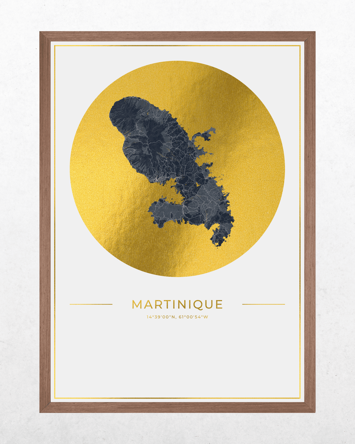 Framed wall art print featuring a dark blue map of Martinique over a large textured gold circle on a white background, with the word MARTINIQUE and small coordinates below. The print is housed in a medium brown wood frame.