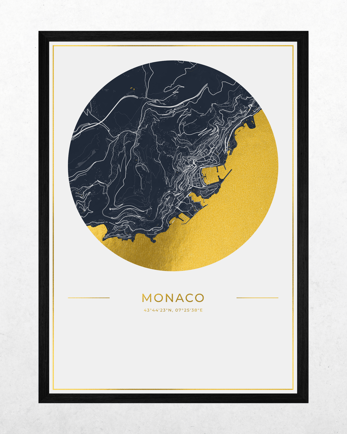 A framed art print featuring a stylized map of Monaco in a circular design, with a navy blue and gold color scheme and white line details, set against a light gray textured background.