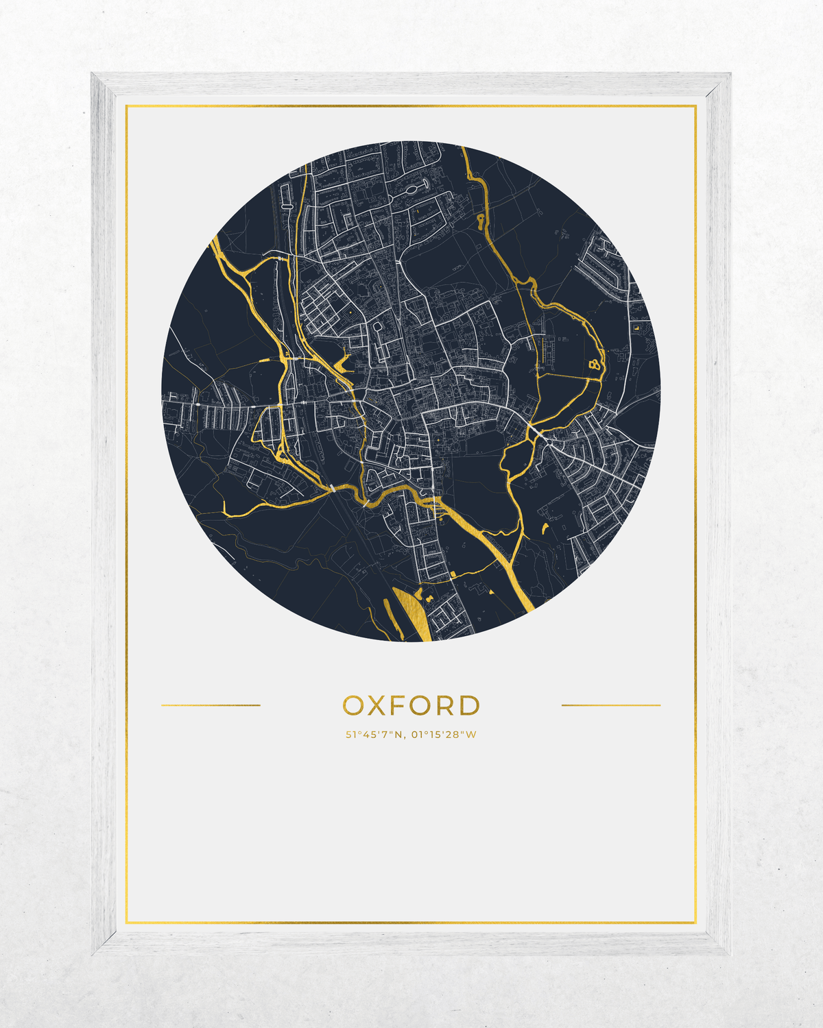 A framed circular city map print of Oxford, featuring a dark navy blue map with gold rivers and the city name 'OXFORD' in gold below, set in a white frame against a light textured background.