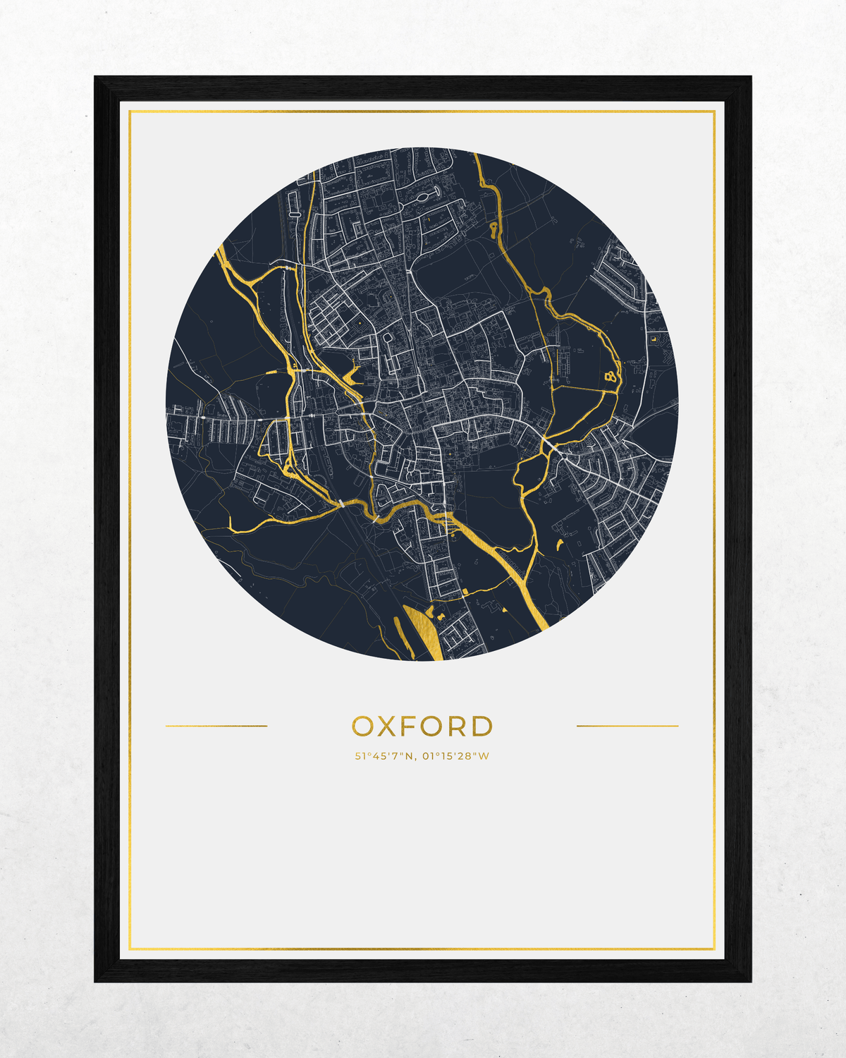 A framed circular city map print of Oxford, featuring a dark navy blue map with white street lines and gold river routes, set against a white mat and a black frame.