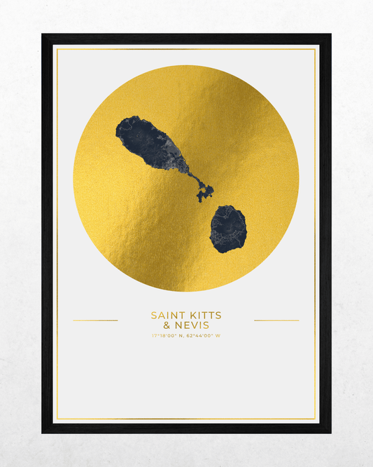 A framed minimalist art print featuring a textured gold circle with dark blue abstract shapes on a white background, with the text 'SAINT-KITTS & NEVIS' and coordinates below. The print is framed in black with a white mat.