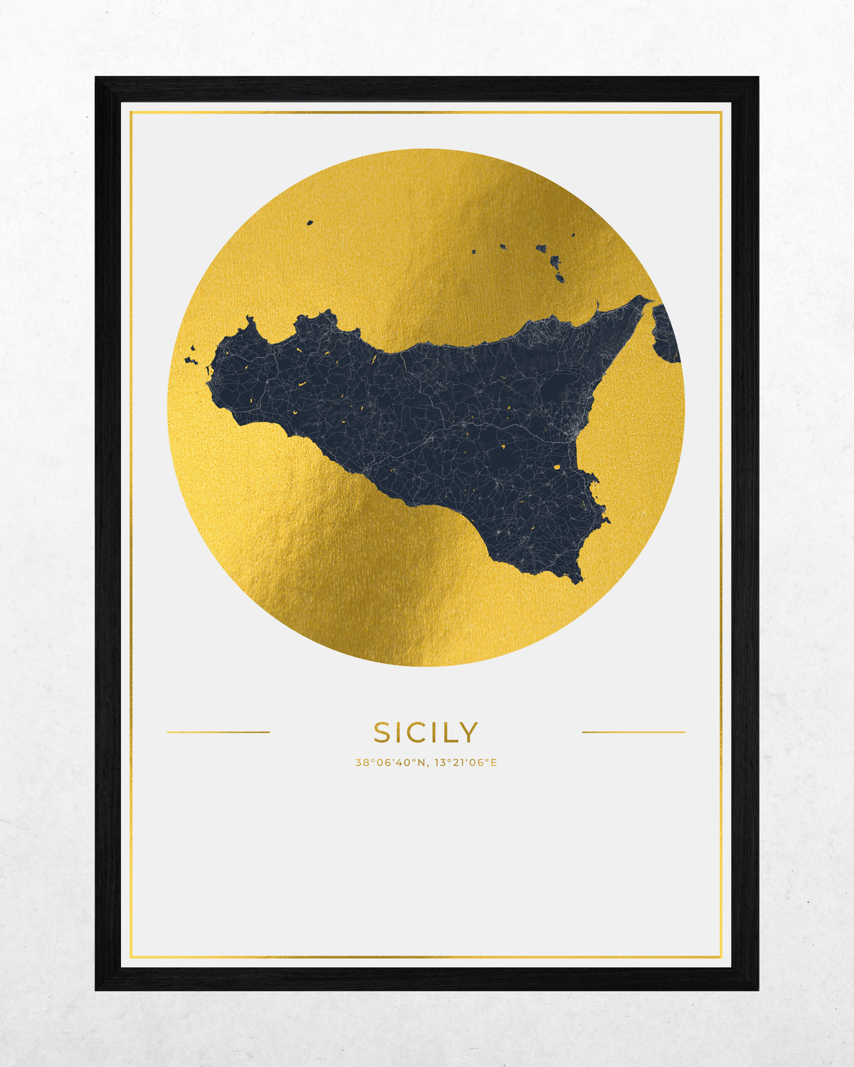A framed minimalist map print of Sicily, featuring a textured gold circular background with a dark navy blue silhouette of the island, and the word 'SICILY' printed below in gold. The print is housed in a black frame with a white mat, set against a light gray textured wall.