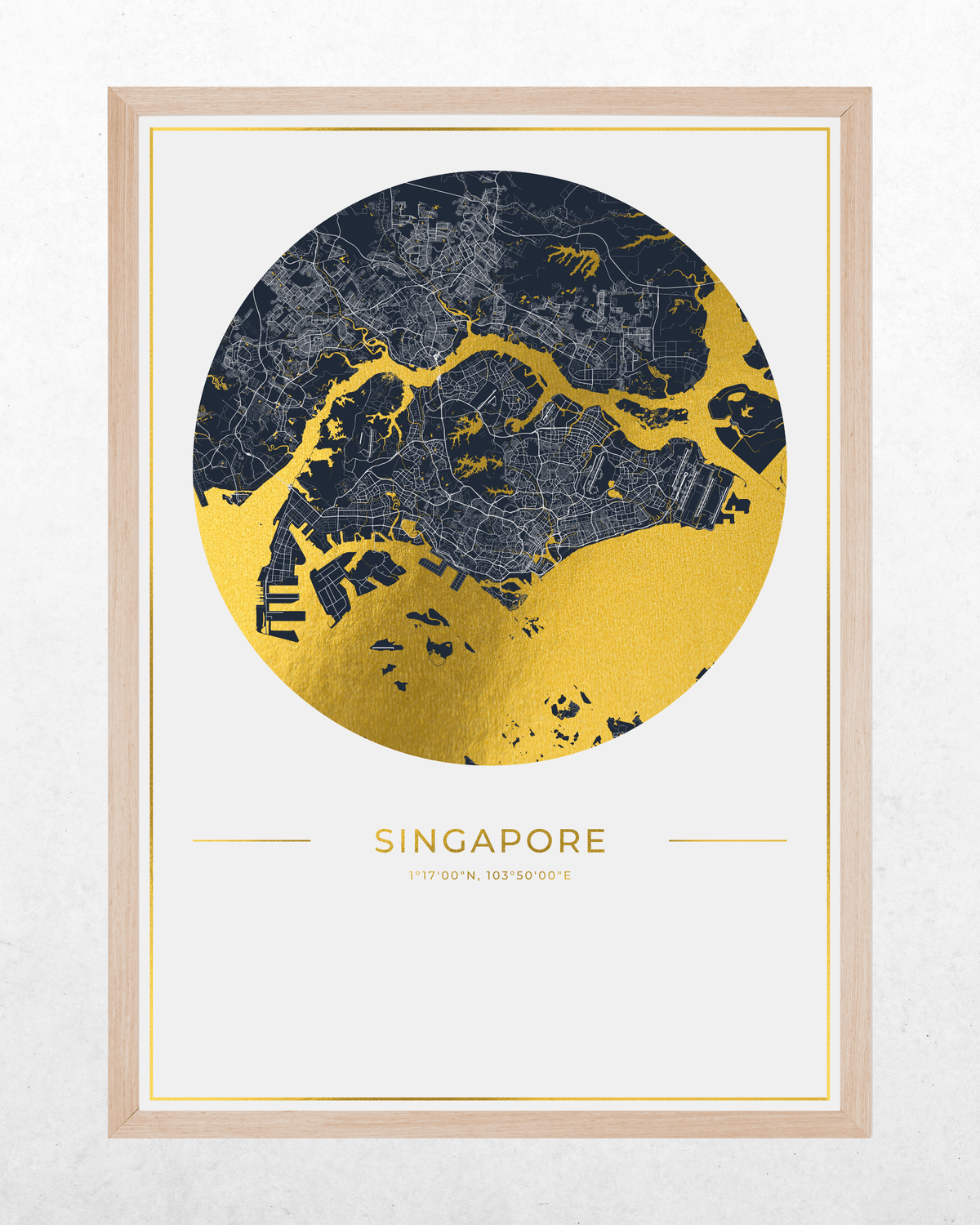 A framed Singapore city map art print featuring a circular map design in dark navy and metallic gold with the text 'SINGAPORE' and coordinates below, set in a light wood frame against a white wall.