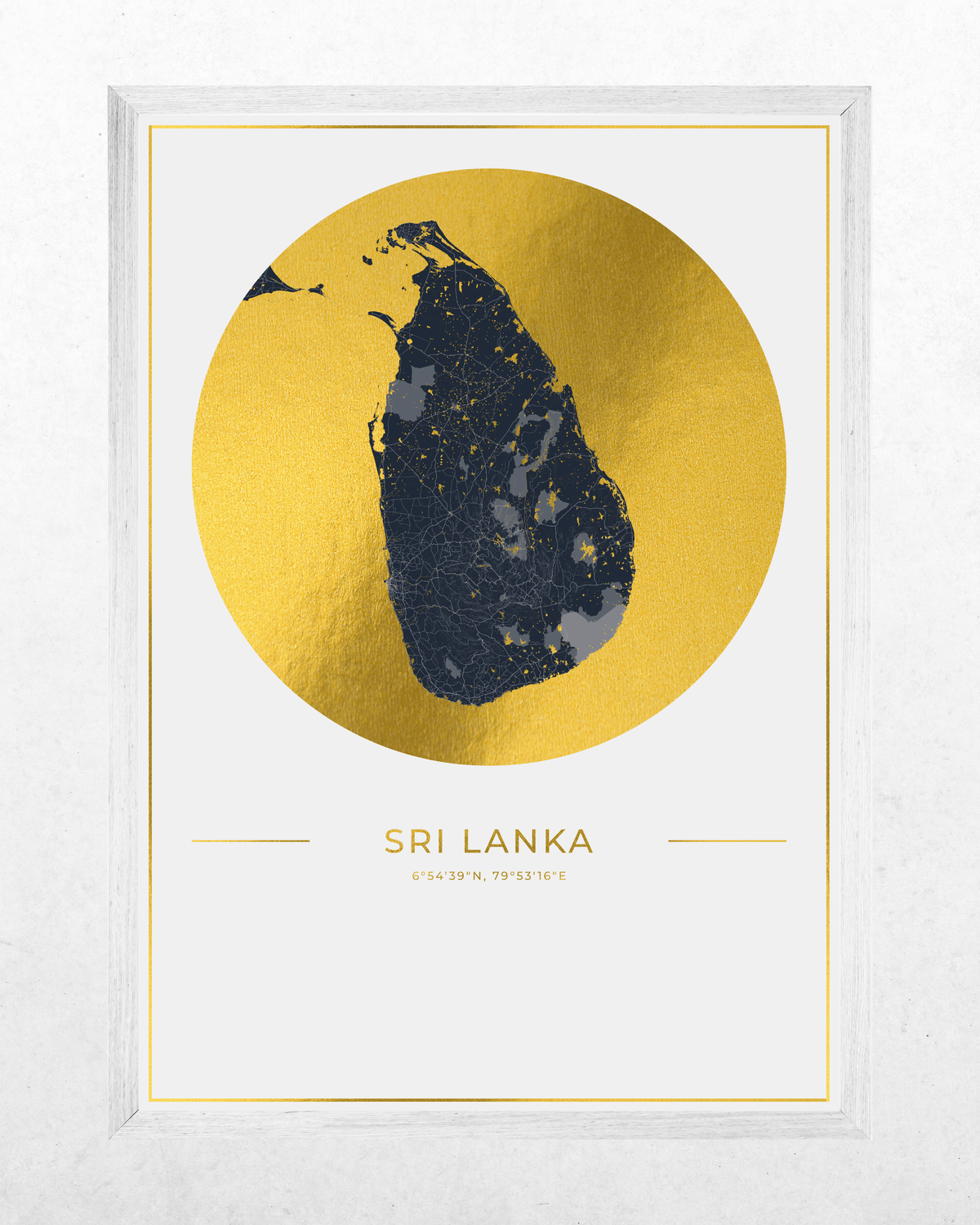 Framed minimalist art print of Sri Lanka, featuring a dark navy blue silhouette of the island on a large textured gold circle, with 'SRI LANKA' printed below in gold, set in a white frame against a light gray wall.