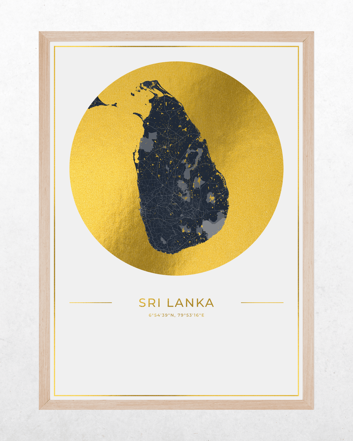 A framed art print featuring a stylized map of Sri Lanka. The map is rendered in a dark navy blue textured pattern over a large, metallic gold circular background.