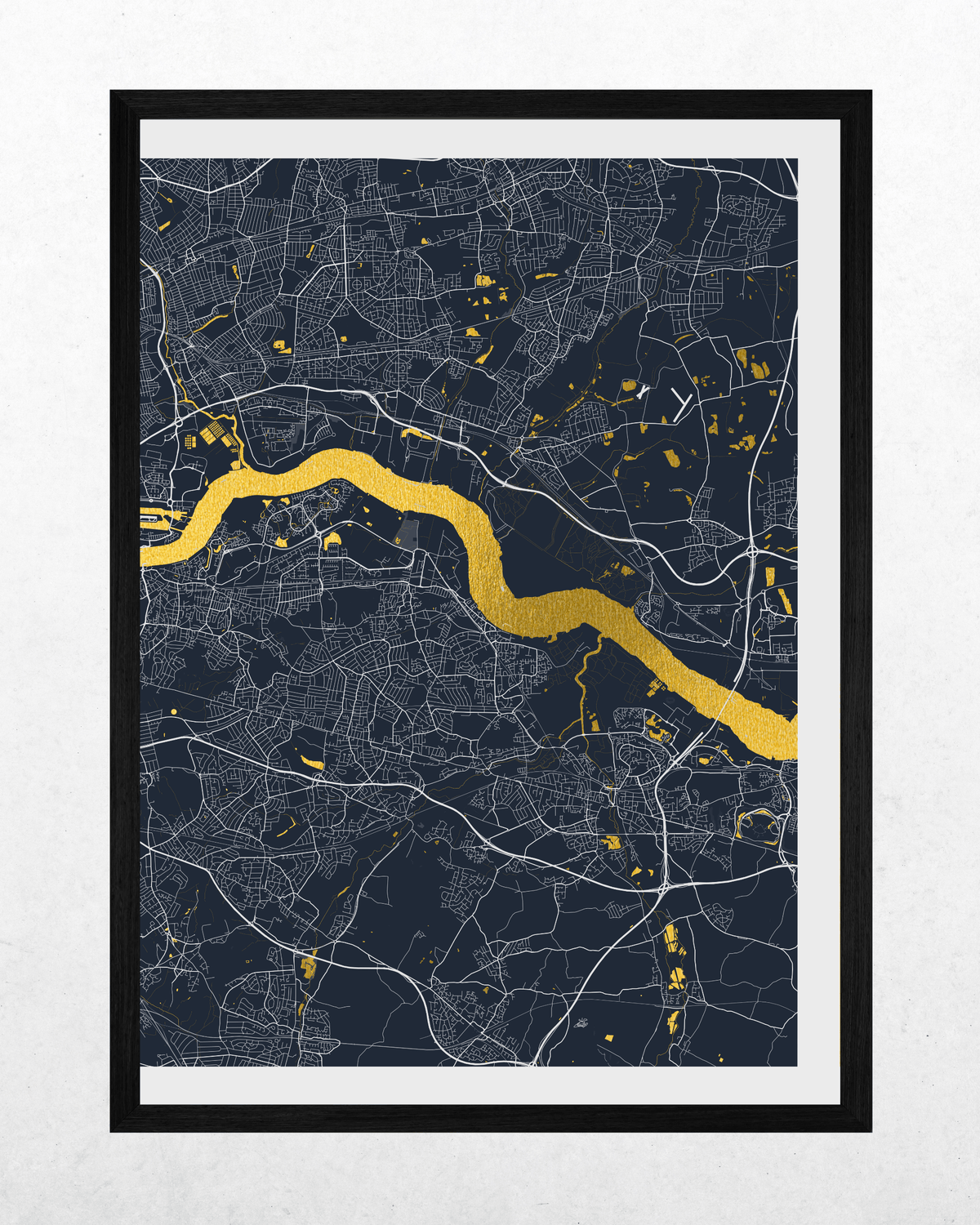 A framed minimalist map print of London, featuring a dark navy background with white street lines and a bright gold river running diagonally through the center, enclosed in a black frame with a white mat.